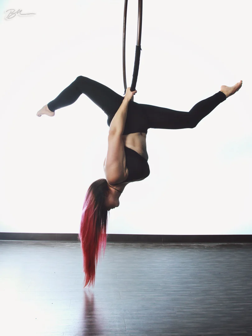 Performer demonstrating lyra aerial hoop techniques