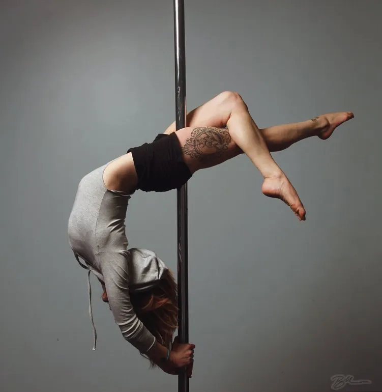 Student performing pole dance moves