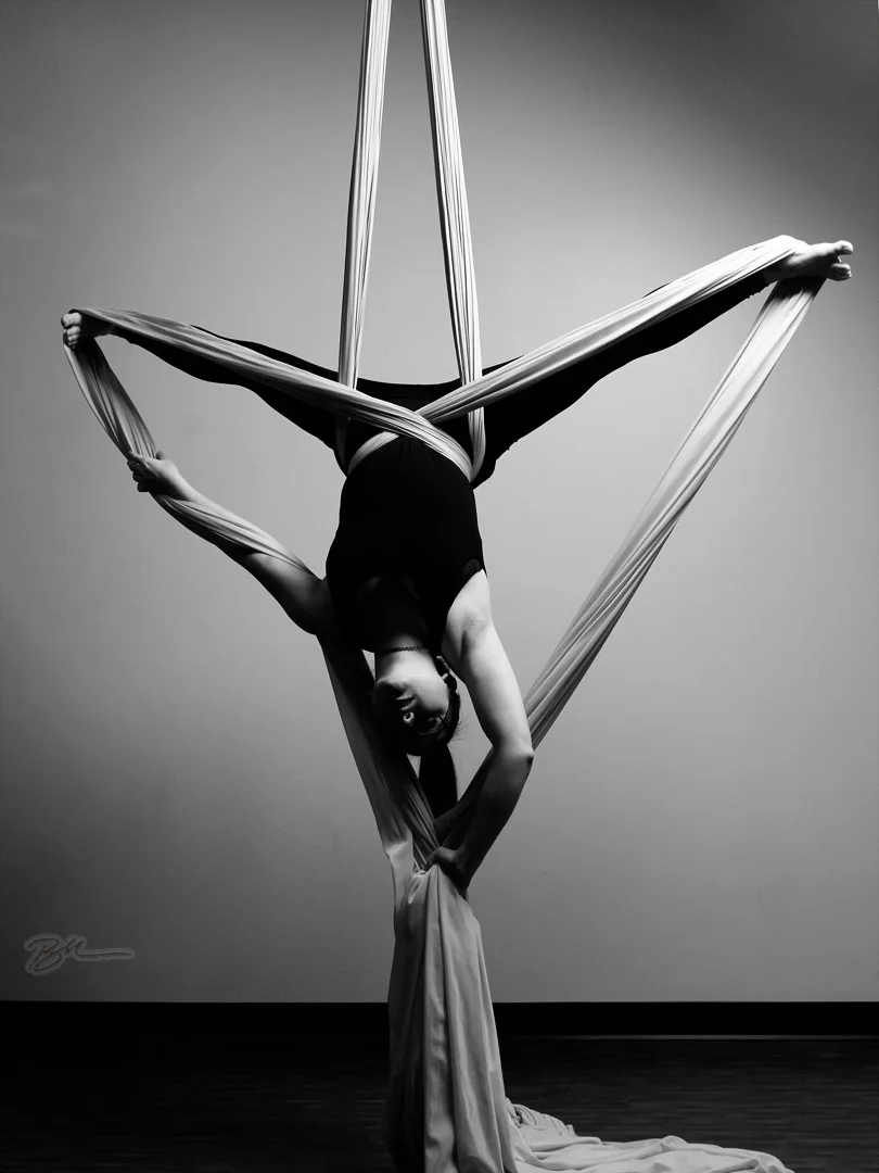 Aerial artist gracefully performing on silks